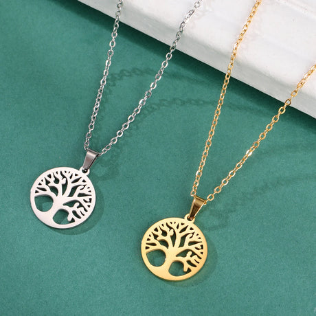 Two tree-shaped pendants on chains against a teal background