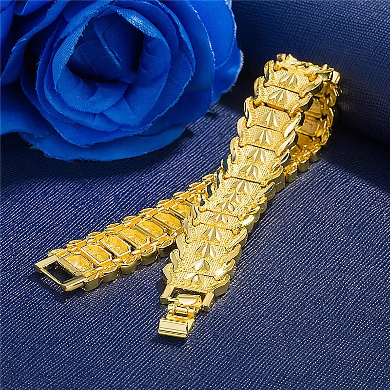 Gold bracelet on a blue fabric background with a blue rose.