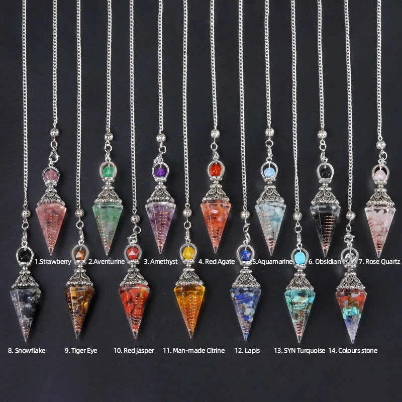 Set of crystal pendulums with colored stones on silver chains against a black background.