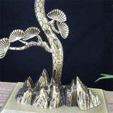 Metallic sculpture of a tree with abstract mountain-like base on a dark background
