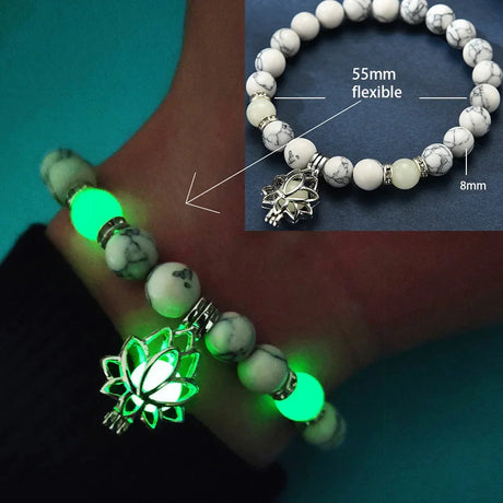 Glowing bracelet with lotus charm on a hand, close-up of bracelet details.