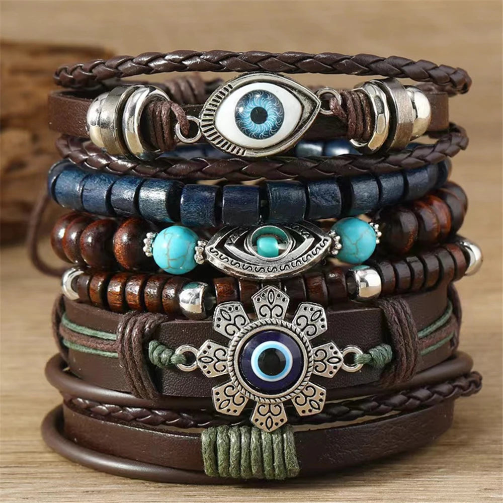 Stack of leather and beaded bracelets with eye-shaped charms on a wooden surface