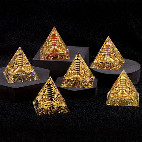 Set of gold pyramids on black stands against a black background