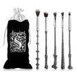 Set of makeup brushes with decorative handles resembling wands, next to a branded black pouch.