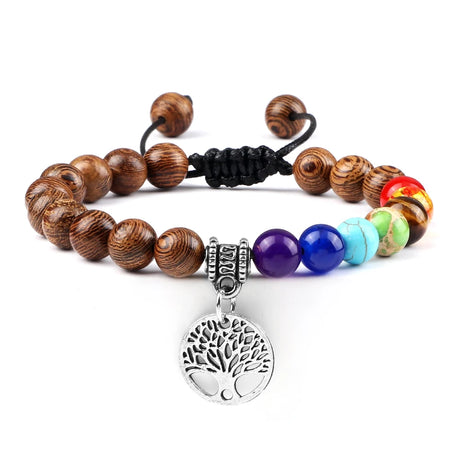 Bracelet with wooden beads, colorful gemstones, and a silver tree of life charm on a white background