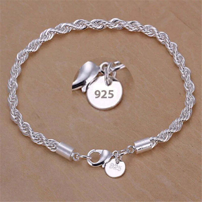 Silver bracelet with charms on a beige background