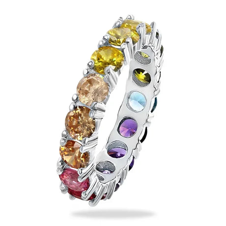 Silver ring with multicolored gemstones on a white background