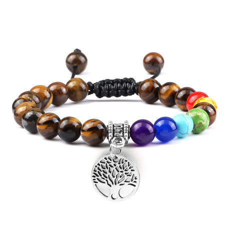 Multicolored beaded bracelet with a silver tree of life charm on a white background