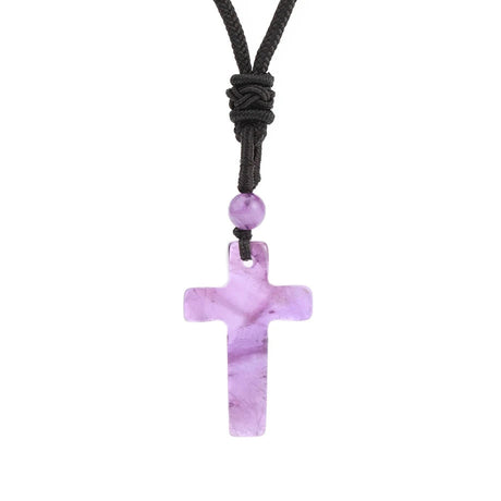 Purple cross pendant necklace with a black cord on a white background