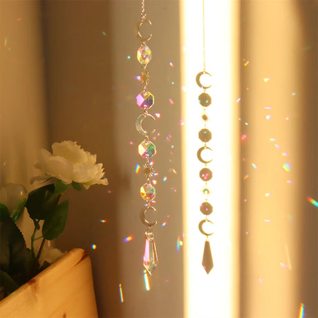 Decorative hanging crystal with rainbow, placed against a neutral background.