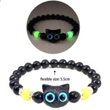 Black beaded bracelet with cat-shaped beads on a white background