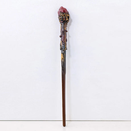 Decorative wand with intricate design on a white background