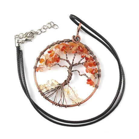 Tree of Life pendant with orange and clear stones on a black cord against a white background