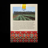 Product packaging with a scenic image of a field and text on a black background