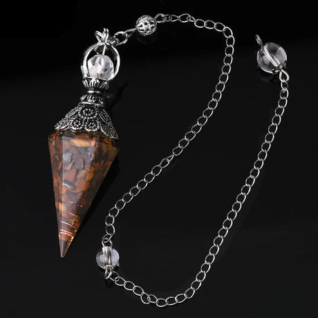 Crystal pendulum with chain on a black background