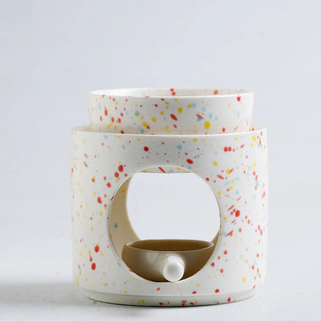 Two ceramic containers with colorful speckled pattern on a white background