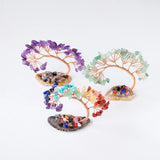 Colorful crystal tree sculptures on a white background