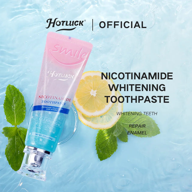 Hotluck Swalla Nicotinamide Whitening Toothpaste with lemon slices and mint leaves on a light blue background