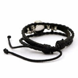 Black braided bracelet with metal clasp on a white background