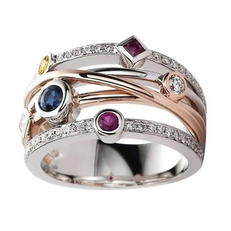 Multicolored gemstone ring with rose gold, silver, and yellow gold accents on a white background