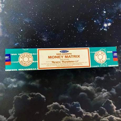 Box of Satya Money Matrix incense on a starry night background