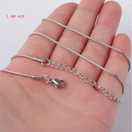 Silver chain necklace on a hand with measurement details.