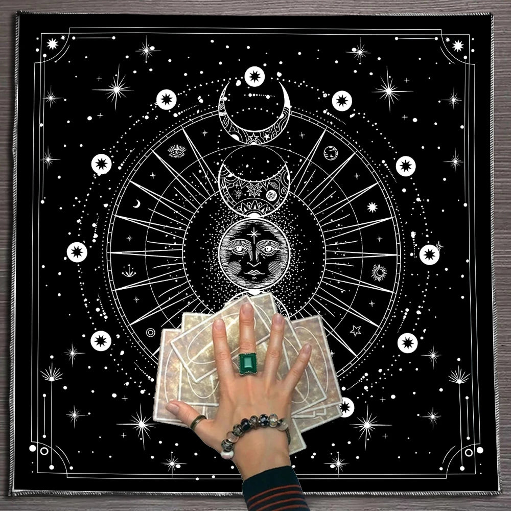 Person holding tarot cards with a black and white astrological design in the background