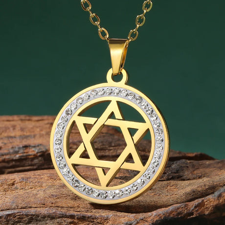 Gold pendant with Star of David design on a wooden surface