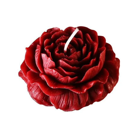 Red rose-shaped candle on a white background