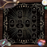 Decorative tarot card spread on a black board with gold accents, surrounded by crystals and candles.