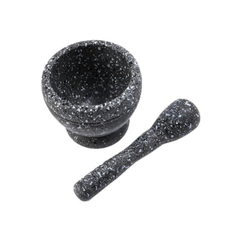 Black speckled mortar and pestle on a white background