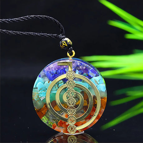 Multicolored pendant with gold symbol on a black background