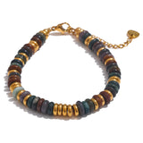 Bracelet with multicolored beads and gold accents on a white background