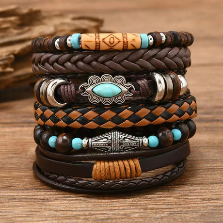 Stack of leather bracelets with beads and metal accents on a wooden surface