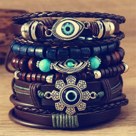 Stack of decorative bracelets with eye designs on a wooden surface