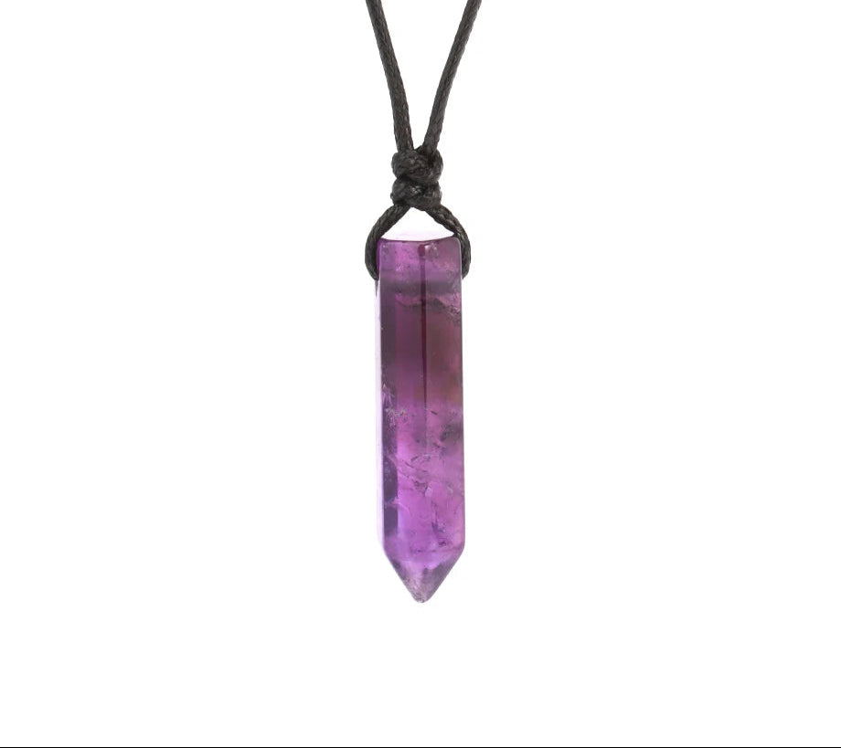 Purple crystal pendant on a black cord against a white background
