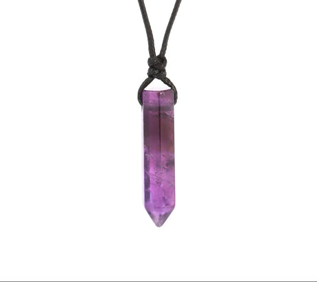 Purple crystal pendant on a black cord against a white background