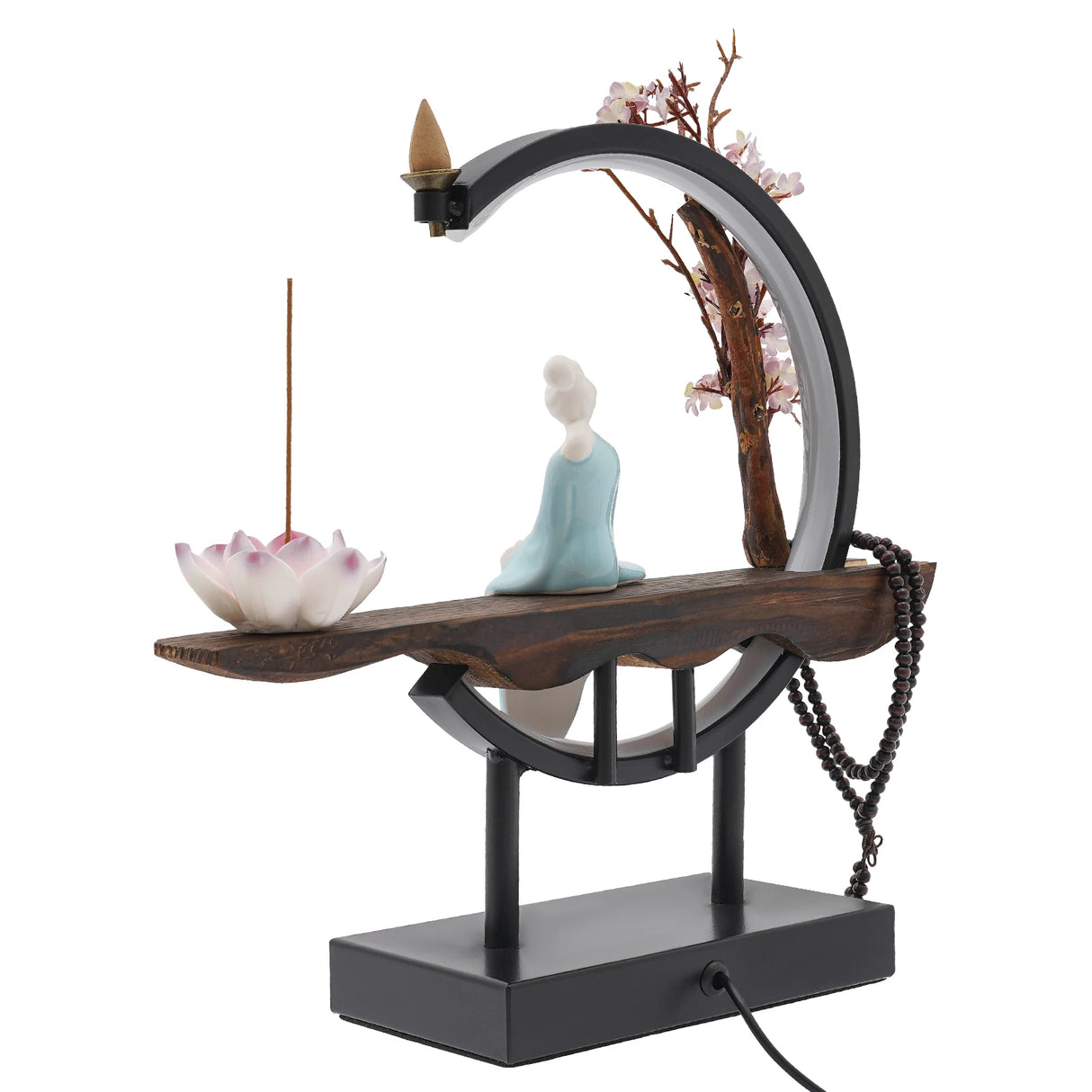Decorative incense burner with a figurine, lotus flower, and cherry blossom branch on a white background