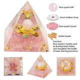 Rose quartz crystal pyramid with chakras array and rose quartz gravel on a white background