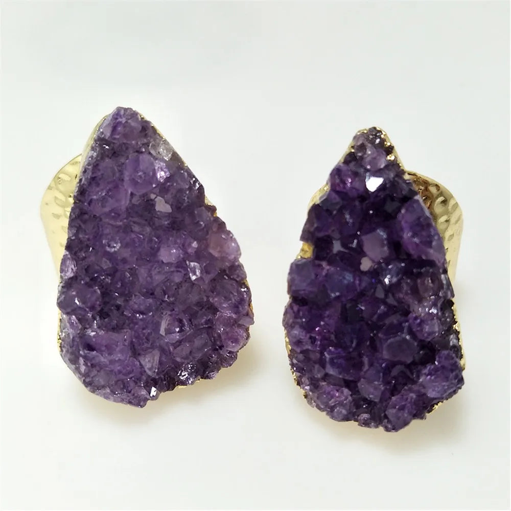 Pair of purple crystal earrings on a white background