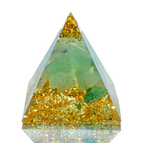 Crystal with gold and green inclusions on a white background