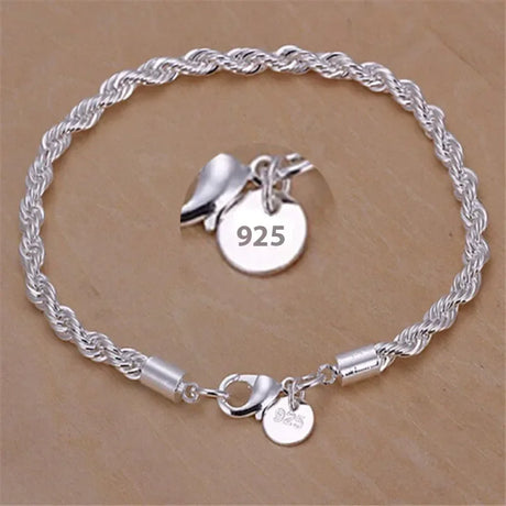 Silver bracelet with a '925' tag on a beige background