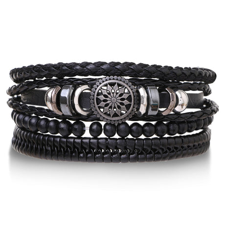 Stack of black leather and beaded bracelets with metal accents on a white background