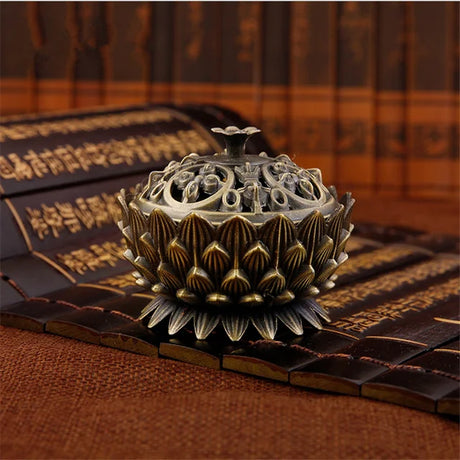Decorative incense burner on a textured surface with a blurred background