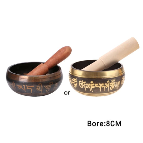 Two singing bowls with wooden mallets on a white background