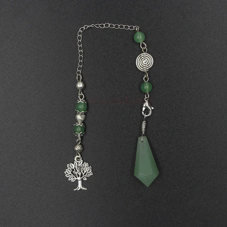 Decorative bookmark with green beads, silver tree charm, and green stone on a dark background