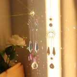 Decorative hanging crystal with rainbow, placed against a neutral background.