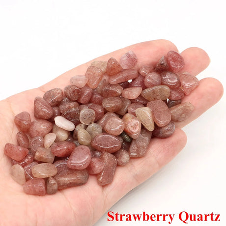 Hand holding strawberry quartz stones with a white background