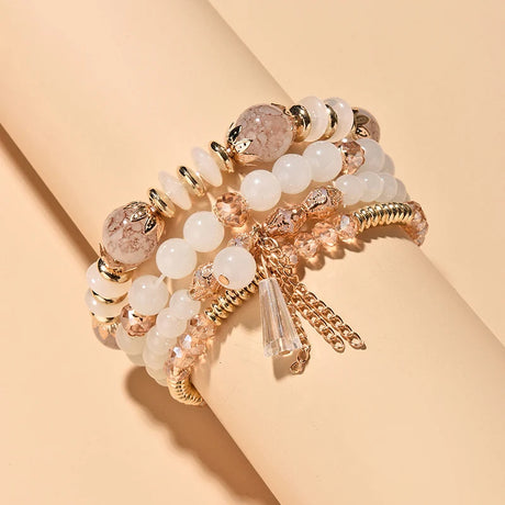 Beaded bracelet with gold accents on a beige background