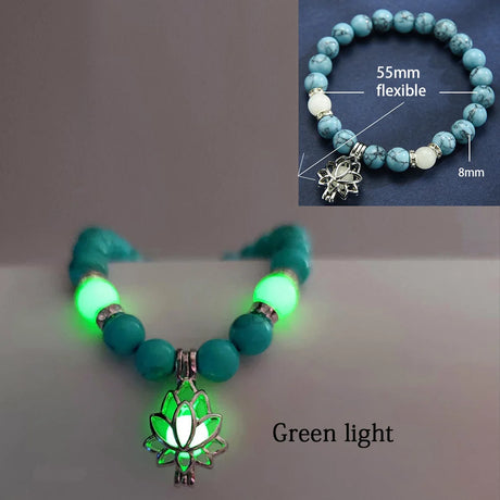 Necklace with glowing green beads and lotus charm on a white background